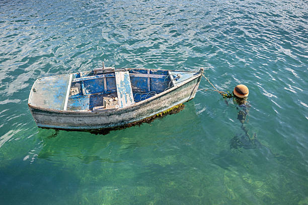 A barge stranded in coastal waters off Seberang Takir, Kuala Terengganu. Tongkangs are typically large, wooden boats with flat bottoms, designed to carry heavy loads, especially in shallow waters. \nbarge, stranded, coastal, waters, Tongkangs, boat, vessel, flatbottom, transport, heavyload, shallow, marine, cargo, tide, grounded, traditional, maritime, sea, shoreline, drift, navigation, moored, abandoned, seafaring, dock, ocean, hull, tideout, bay, structure, seatrade, freight, utility, fishing, timber, weathered, rustic, nautical, current, straits, coastalzone, bulkcarrier, anchor, tidebound, island, estuary, bargeboat, watercraft, seascape, marinevessel