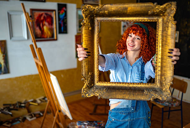 Female artist with a curly hair in her art workshop