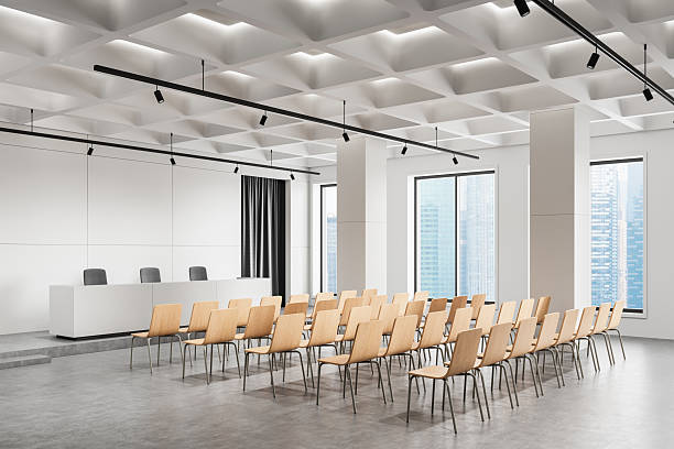 istock Modern conference hall with wooden chairs and white podium. 3D Rendering 2211224511