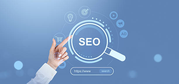 istock SEO search engine optimization concept with digital marketing icons on a blue background. Business hand interacting with holographic interface. 2211225073
