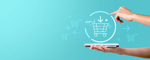 istock Online shopping concept with holographic cart on mobile device. 2211225100