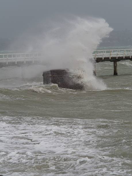 istock Stormy Ocean Waves Crash Against Pier 2211226447