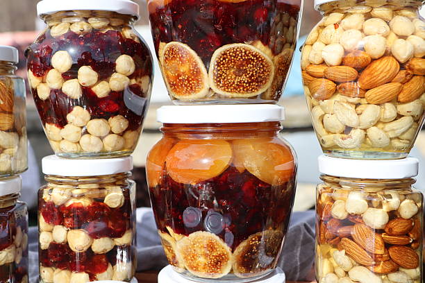 A Stunning and Colorful Collection of Jars Filled with Preserved Fruits and Nuts