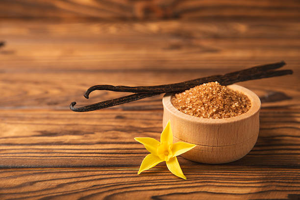 istock Aromatic vanilla sugar. Vanilla pods. Vanilla sticks, brown and white sugar in a bowl on a textured background. Vanilla flowers, spices and herbs for desserts and baking. Space for text. Copy space 2211229444