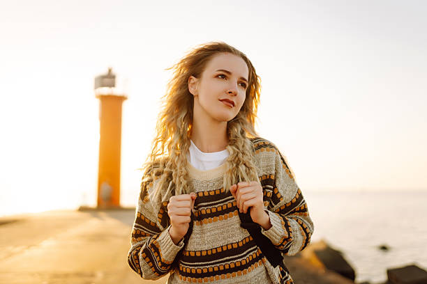 istock Young female hiker walking along a coastal path at sunset. 2211231986