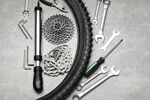 istock Parts of bicycle and tools on light grey table, flat lay 2211232054