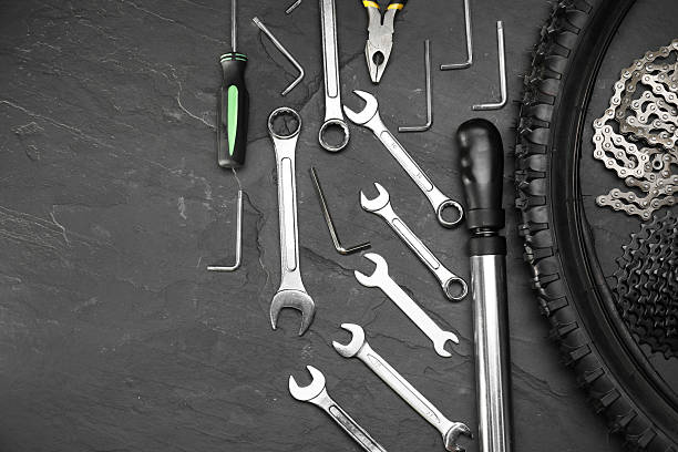 istock Parts of bicycle and tools on black table, flat lay. Space for text 2211232061