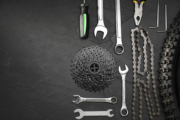 istock Parts of bicycle and tools on black table, flat lay. Space for text 2211232065