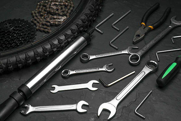 istock Parts of bicycle and tools on black table 2211232068