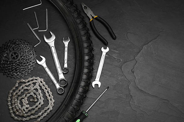 istock Parts of bicycle and tools on black table, flat lay. Space for text 2211232076