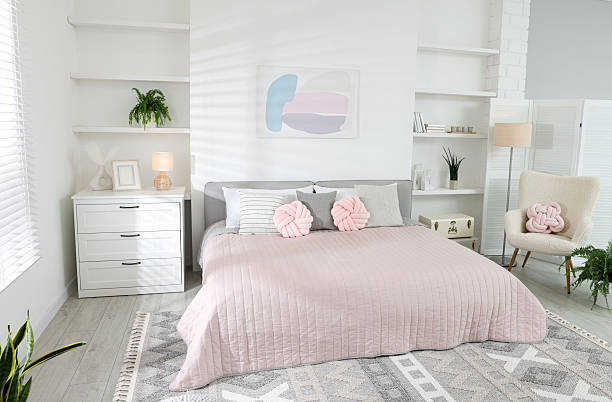 istock Large bed, houseplants and decorative elements in room. Stylish bedroom interior 2211232177