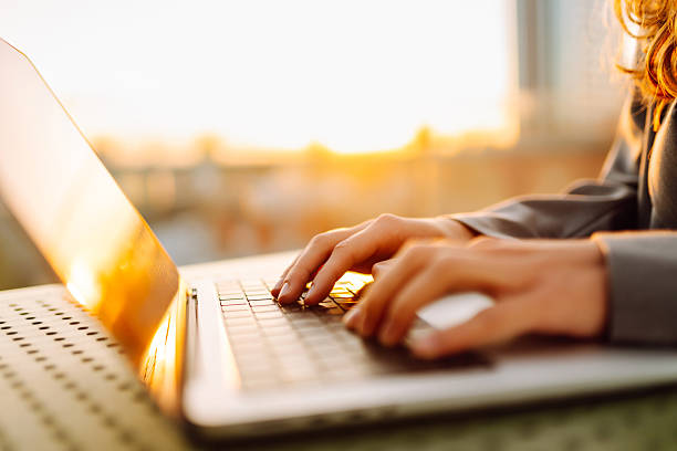 istock Close-up of hands typing on a laptop. 2211233665