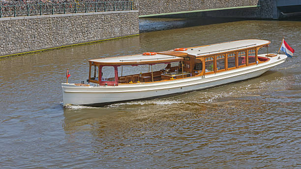Retro Style Long Boat Cruise at Canal in Amsterdam Netherlands