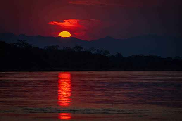 istock Fiery Sunset Reflection over River in Panyame, Mozambique 2211237039