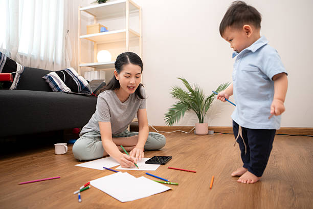 istock While in vacation at home, a mother engages in drawing activities with little kid 2211237276