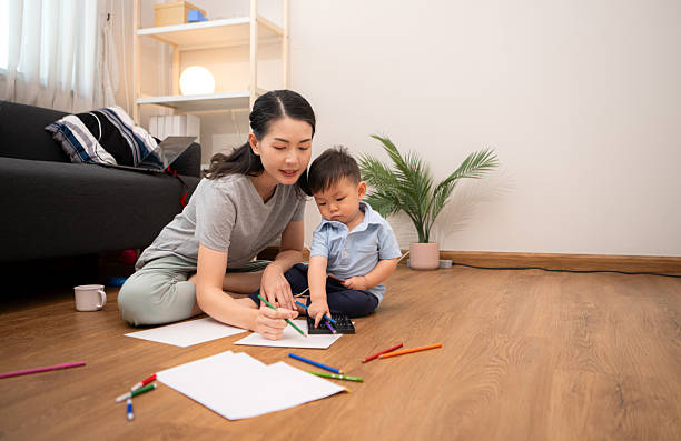 istock While in vacation at home, a mother engages in drawing activities with little kid 2211237283