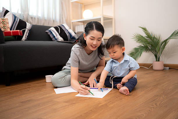 istock While in vacation at home, a mother engages in drawing activities with little kid 2211237800