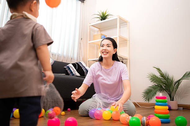 istock While in vacation at home, a mother engages in activities with little kid 2211237846