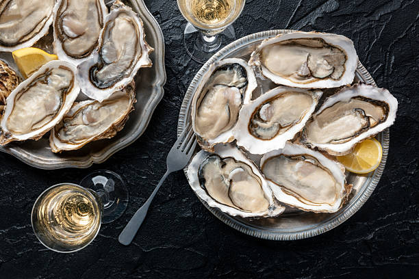 istock Fresh raw oysters on ice, overhead flat lay shot 2211241034