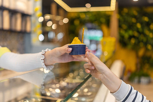 Boy buying ice-cream at parlor