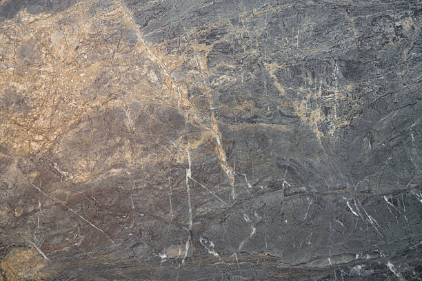 Dark marble texture with golden veins and natural patterns