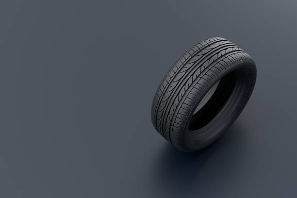 Several stacks of used car tires rest on metal racks inside a clean, modern garage. The worn treads and organized storage suggest a professional automotive environment.