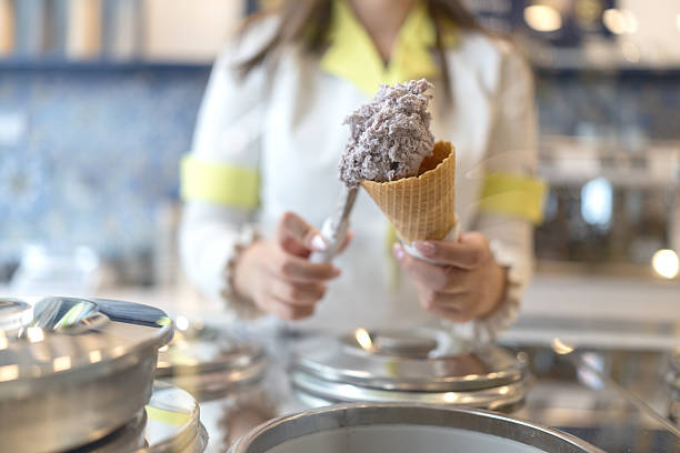 istock Young woman working at an ice cream parlor 2211243284