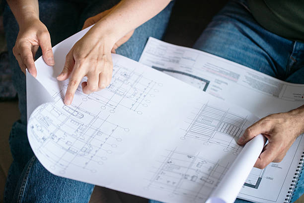 istock Collaborating on Architectural Blueprint Plans for a New Structure or Building Design 2211243614