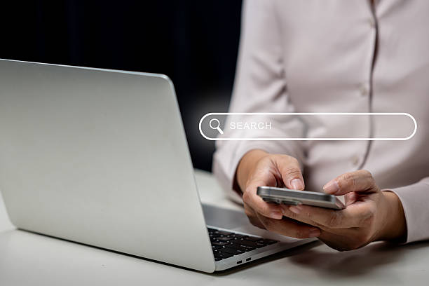 istock Businessperson using a mobile phone with a search engine bar icon sign. Technology innovation on a virtual screen. Concept of Data information and network web 2211244362