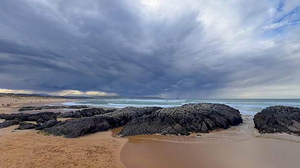 istock Stormy Sky Over Rocky Beach Shoreline 2211246781