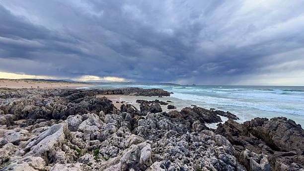 istock Stormy Sky Over Rocky Beach Shoreline 2211246786