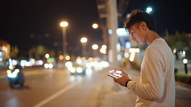 istock Man calling taxi via smartphone at night. 2211247662