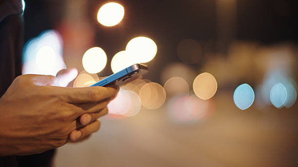 istock Man calling taxi via smartphone at night. 2211247718