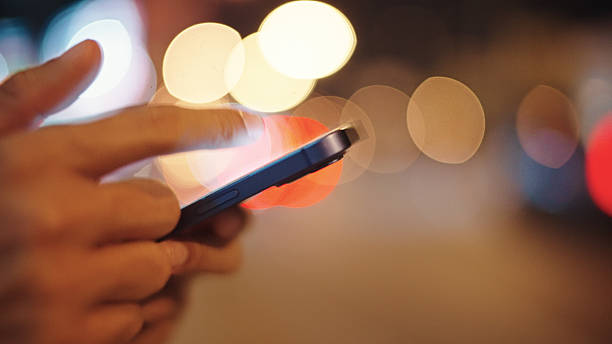 istock Man calling taxi via smartphone at night. 2211247727