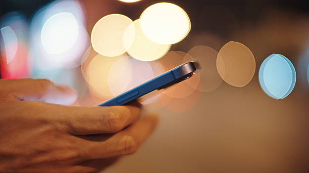 istock Man calling taxi via smartphone at night. 2211247730
