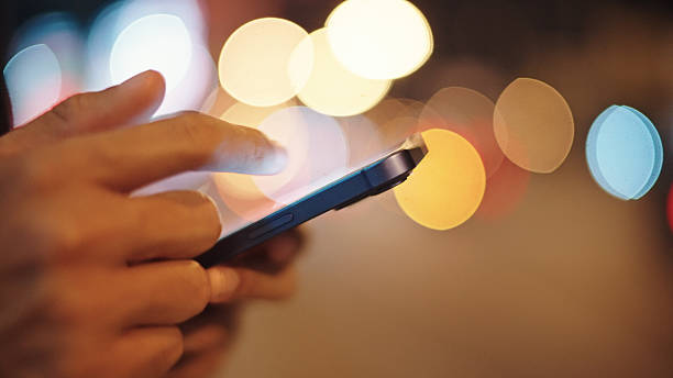 istock Man calling taxi via smartphone at night. 2211247736