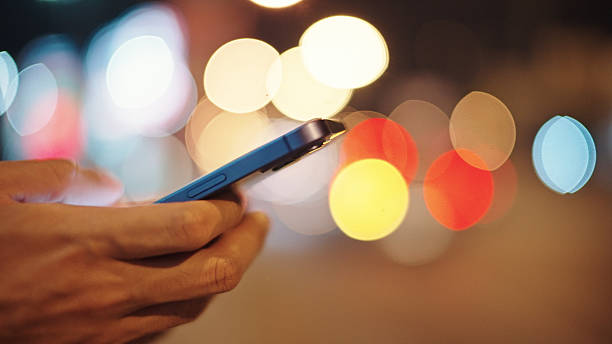 istock Man calling taxi via smartphone at night. 2211247748