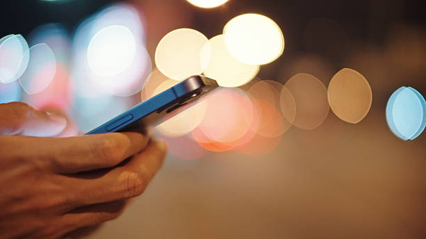 istock Man calling taxi via smartphone at night. 2211247749