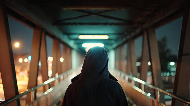 istock Man walking on pedestrian bridge at night. 2211247864
