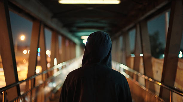 istock Man walking on pedestrian bridge at night. 2211247868