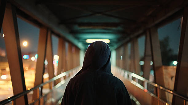 istock Man walking on pedestrian bridge at night. 2211247893