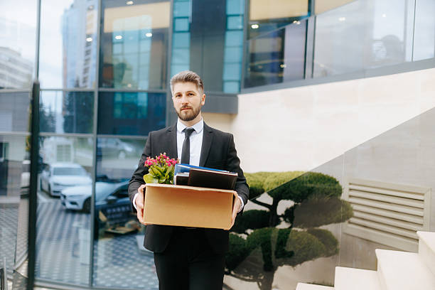 istock Worker experiences emotional dismissal outside modern office building 2211250516