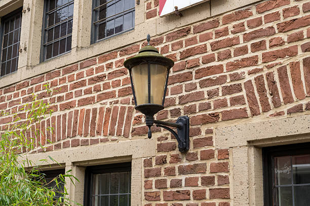 Vintage lantern illuminating a classic brick facade, adding charm to traditional architecture