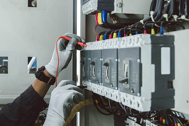 istock Electrician engineer tests electrical installations and wires on relay protection system. 2211255329