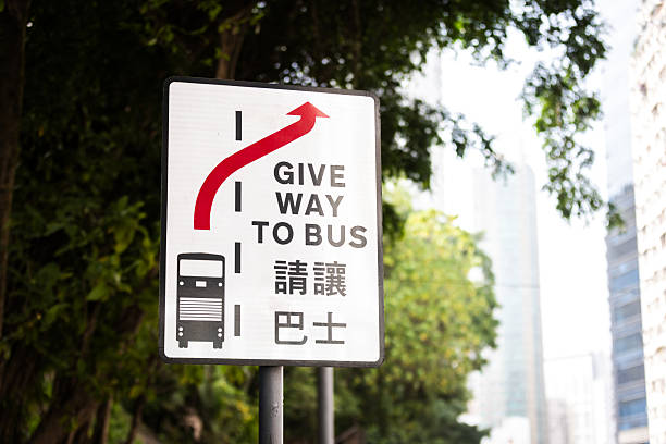 Bus sign on the street with cityscape background.