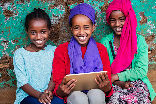 istock African young girls using digital tablet, East Africa 2211257690