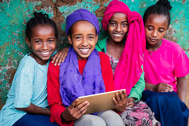 istock African young girls using digital tablet, East Africa 2211257812