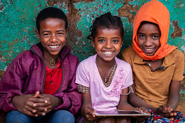 istock African children using digital tablet, East Africa 2211257859