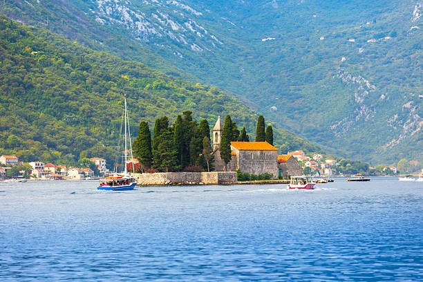 Beautiful mediterranean landscape with St. George Island near town Perast, Kotor bay, Montenegro and tour boats in summer