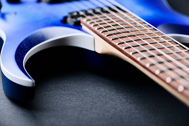 Young man playing a five string bass guitar